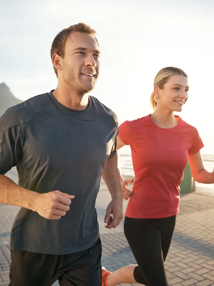 A couple running together outdoors