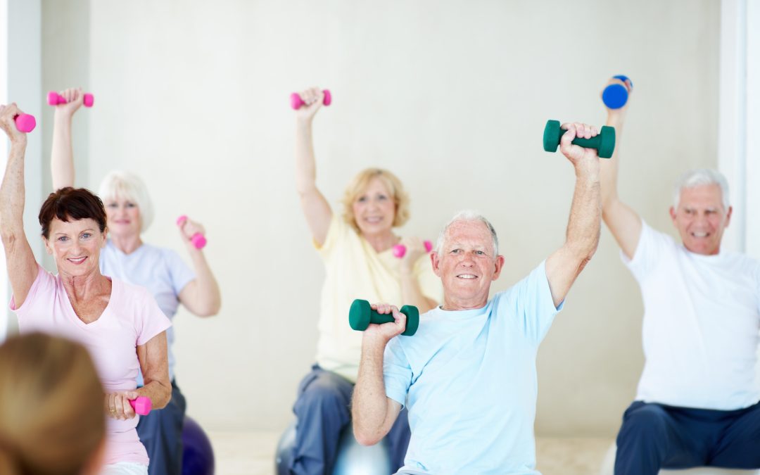 A concierge physician reviewing body composition and strength-training guidance with a member losing weight on a GLP-1 medication at Naples Concierge Health.