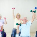 A concierge physician reviewing body composition and strength-training guidance with a member losing weight on a GLP-1 medication at Naples Concierge Health.