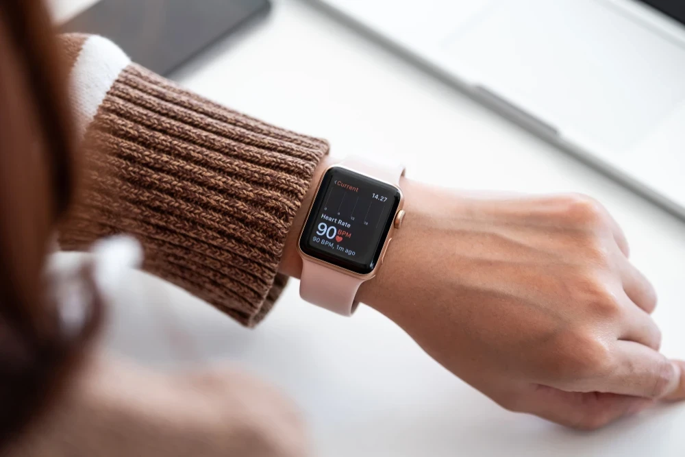 Active adult reviewing wearable health data on a smartwatch with a concierge physician in Naples, Florida.