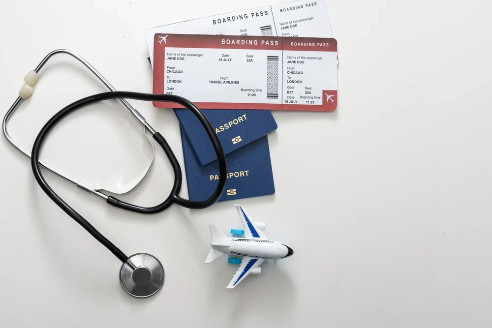 Active adult reviewing travel health documents and medications with a concierge physician in Naples, Florida.