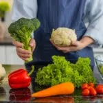 Colorful seasonal vegetables and berries arranged on a kitchen counter, representing phytonutrient-rich preventive nutrition for adults over 50.
