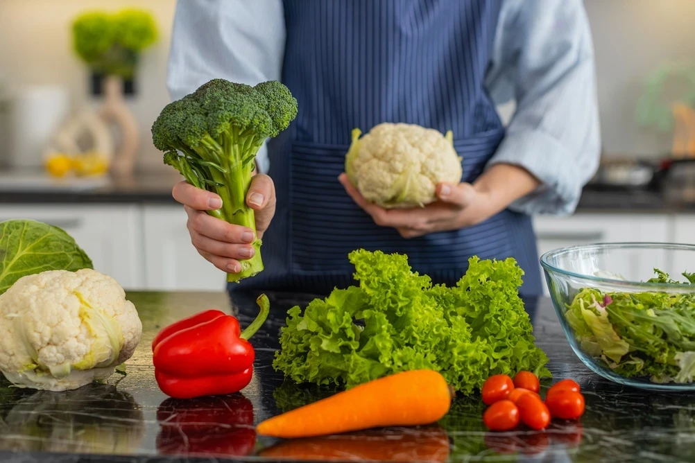 Colorful seasonal vegetables and berries arranged on a kitchen counter, representing phytonutrient-rich preventive nutrition for adults over 50.