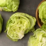 Fresh lettuce being washed in a kitchen sink, representing food safety guidance from a concierge physician in Naples, Florida.
