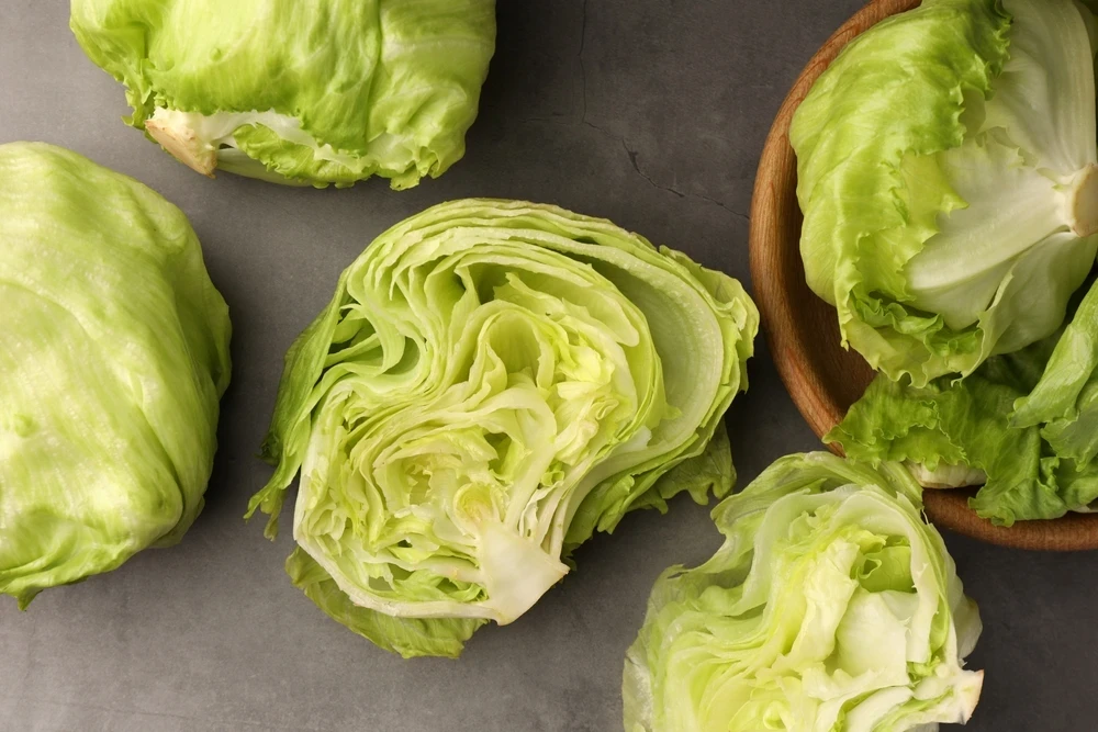 Fresh lettuce being washed in a kitchen sink, representing food safety guidance from a concierge physician in Naples, Florida.